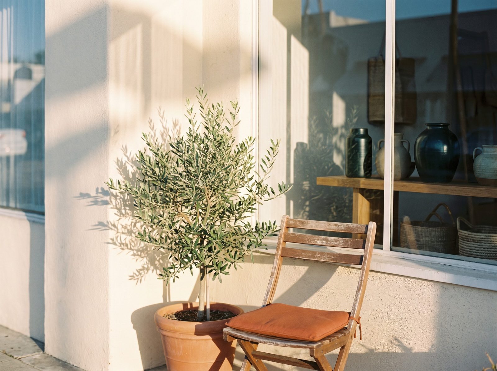 A small shop front in morning sun